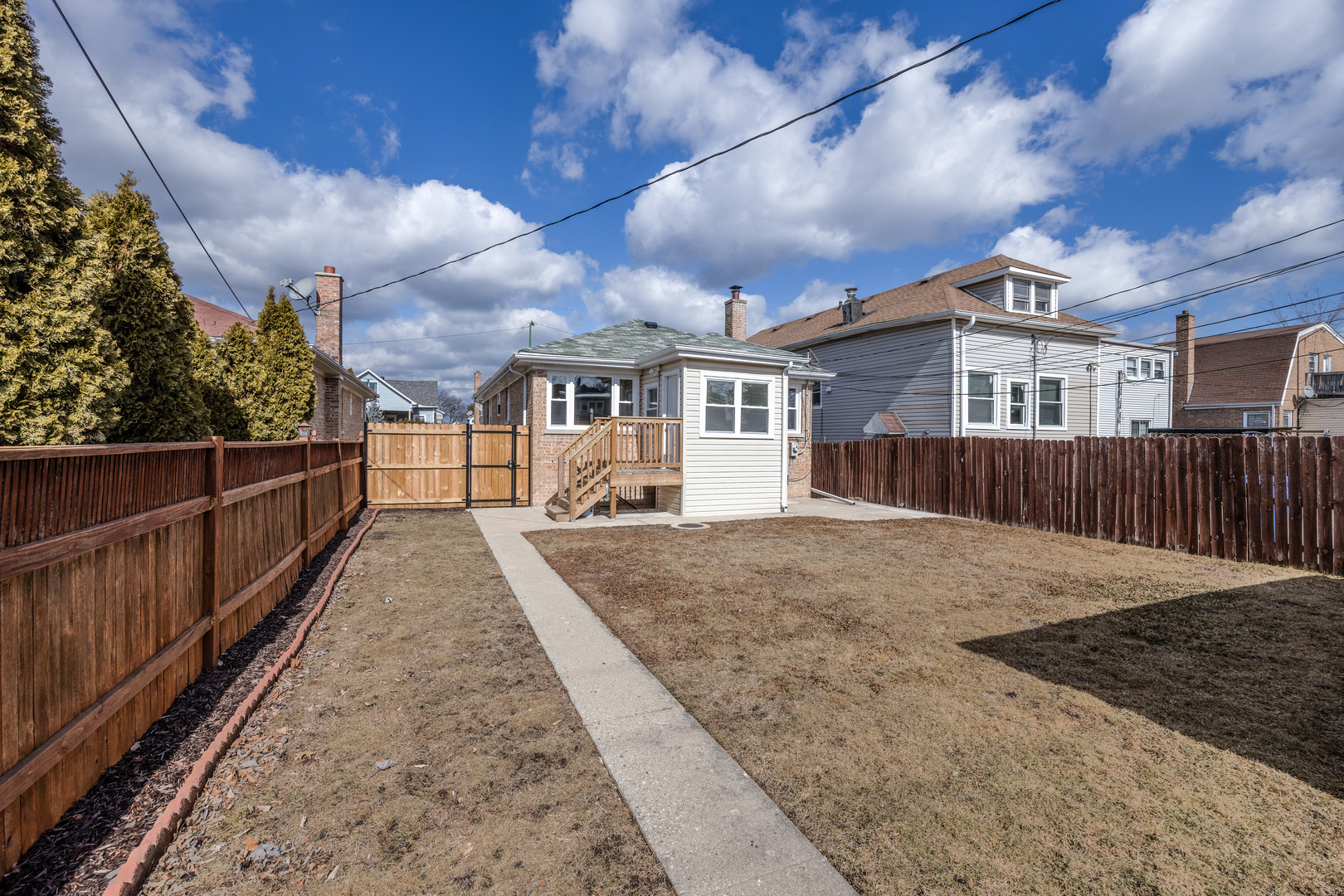 6249 West Addison Street Chicago, IL 60634 - Photo 33 of 35 a view of a house with wooden fence