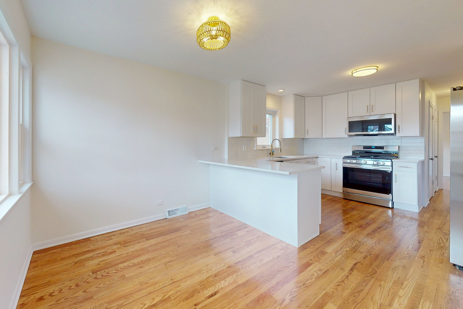 6249 West Addison Street Chicago, IL 60634 - Photo 6 of 35 a kitchen with stainless steel appliances granite countertop a stove a sink and a microwave