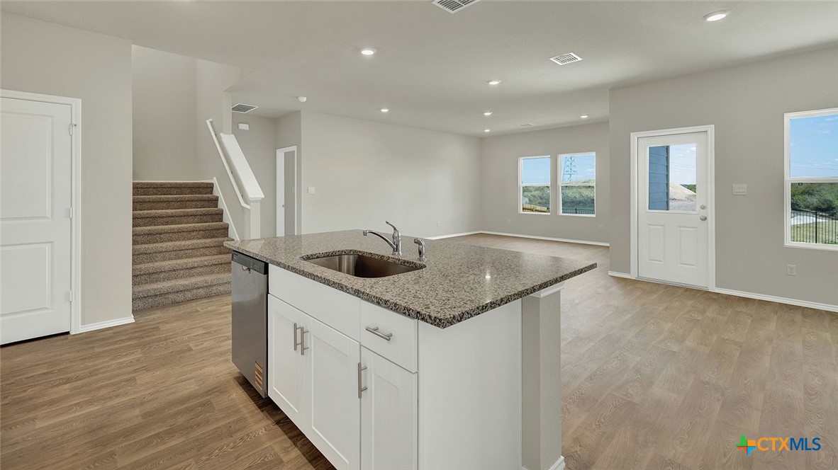 521 Hodges Street Lockhart, TX 78644 - Photo 13 of 40 a kitchen with a sink and stove