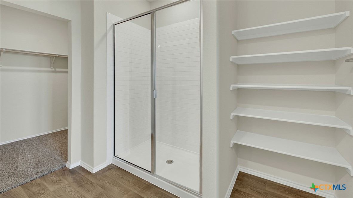 521 Hodges Street Lockhart, TX 78644 - Photo 24 of 40 a view of walk in closet with empty racks