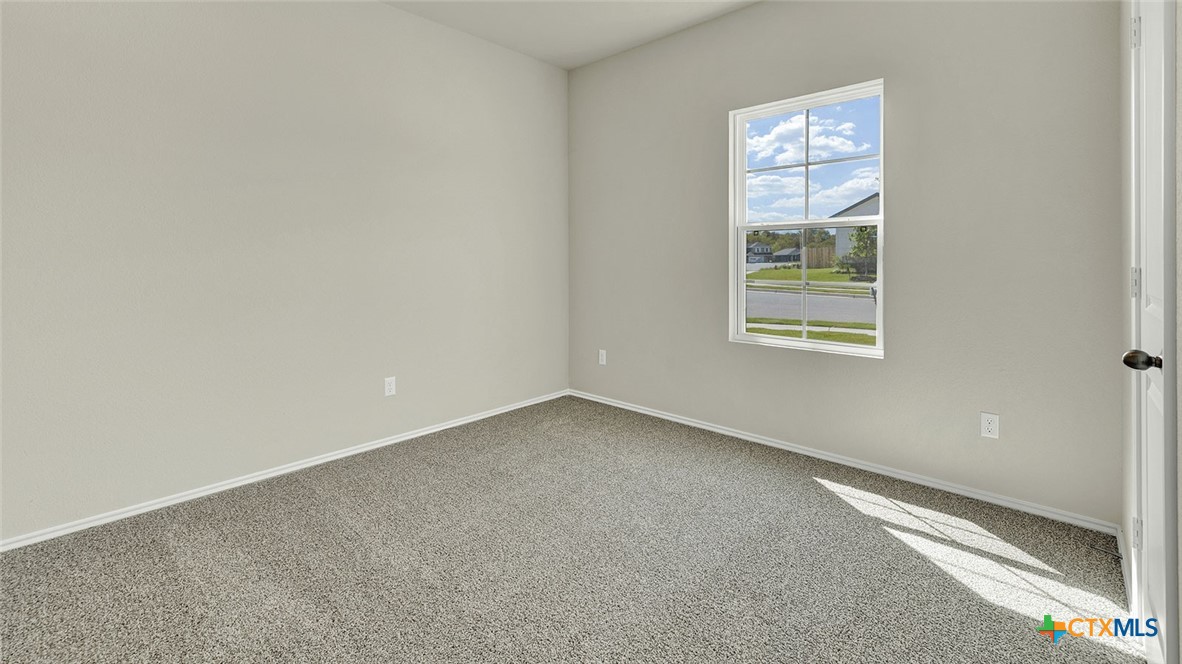 521 Hodges Street Lockhart, TX 78644 - Photo 7 of 40 an empty room with windows