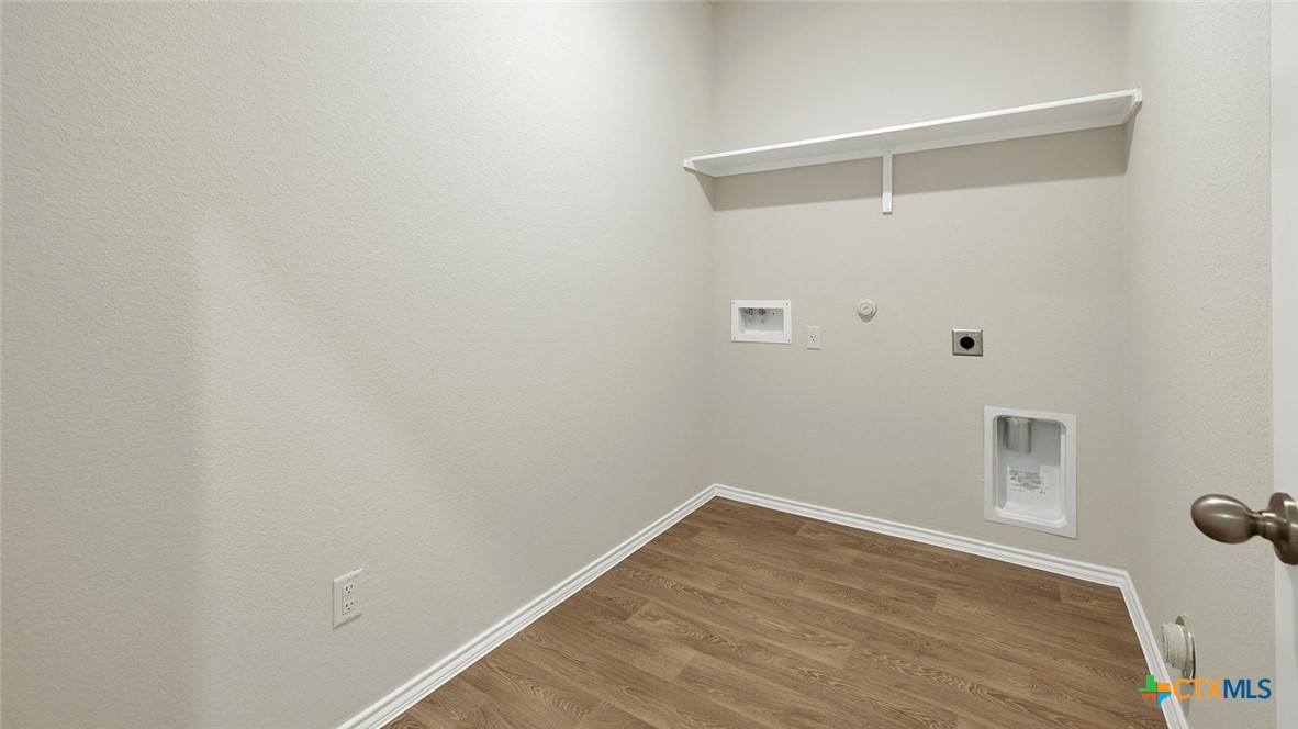 521 Hodges Street Lockhart, TX 78644 - Photo 10 of 40 a view of a room with wooden floor
