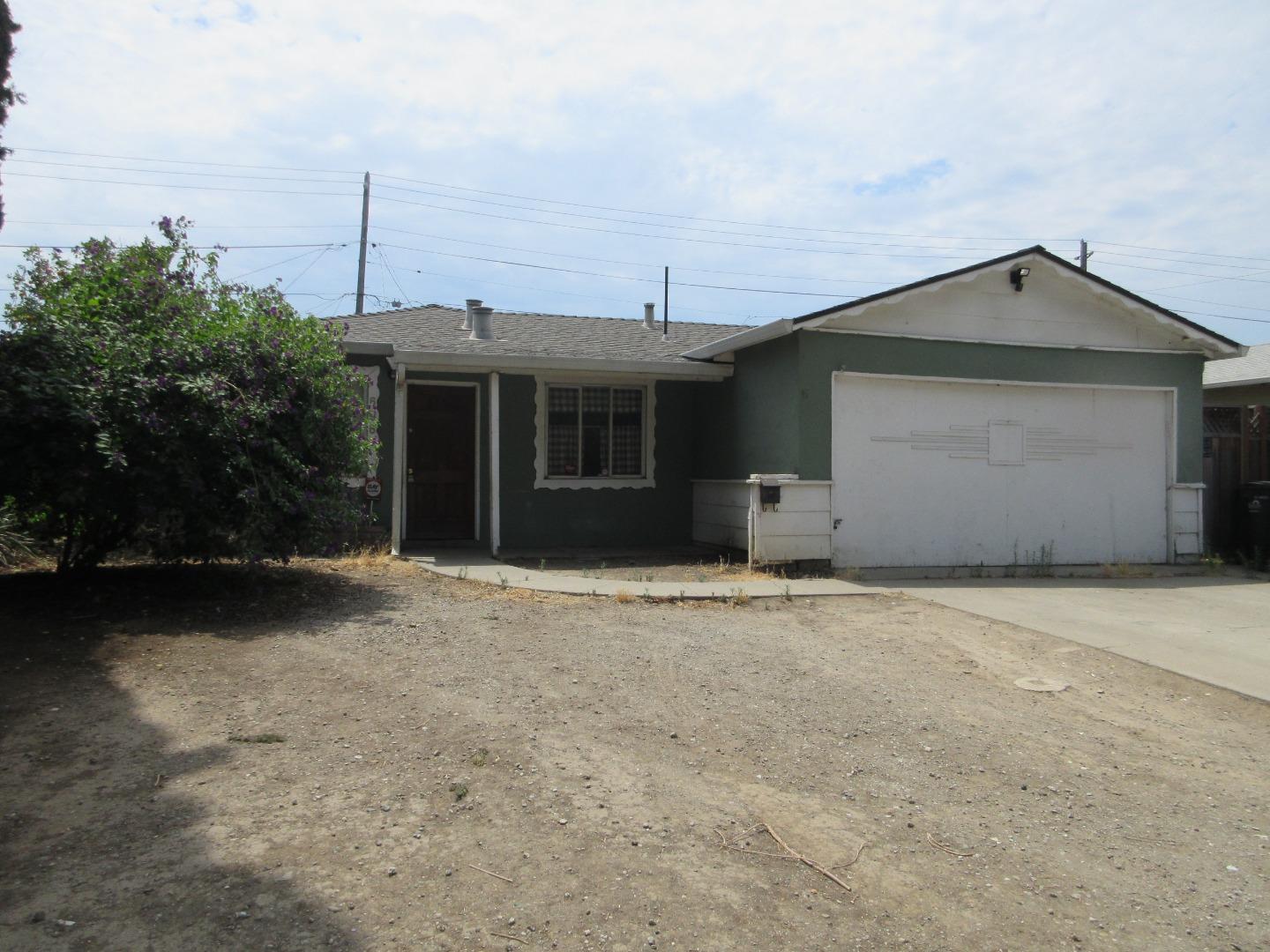 696 Coyote Road San Jose, CA 95111 - Photo 2 of 18 a front view of a house with a garden and garage