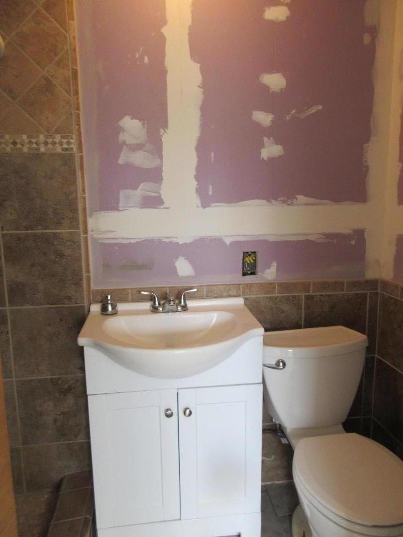 696 Coyote Road San Jose, CA 95111 - Photo 10 of 18 a bathroom with a toilet a sink and mirror