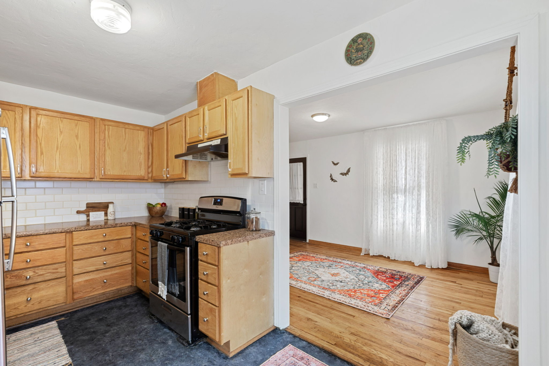 1303 Walnut Avenue Austin, TX 78702 - Photo 4 of 12 a kitchen with stainless steel appliances granite countertop a stove a sink and a microwave