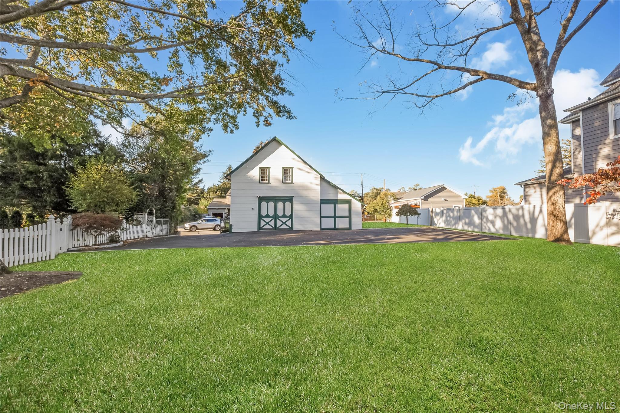 215 Conklin Street Farmingdale, NY 11735 - Photo 11 of 50 a view of a house with a big yard potted plants and large tree