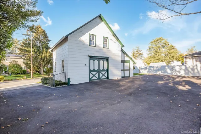 a view of a house with a yard and garage