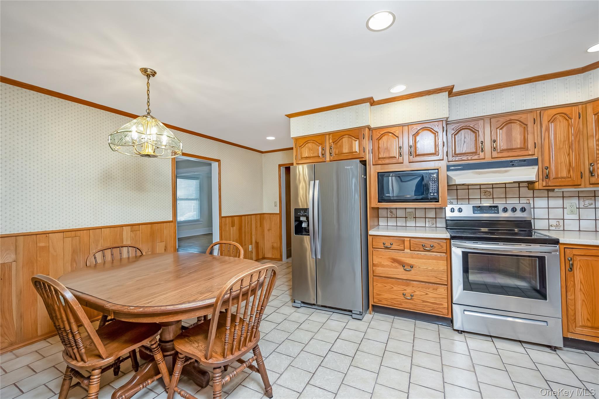 215 Conklin Street Farmingdale, NY 11735 - Photo 17 of 50 a kitchen with stainless steel appliances a stove a refrigerator island and chairs
