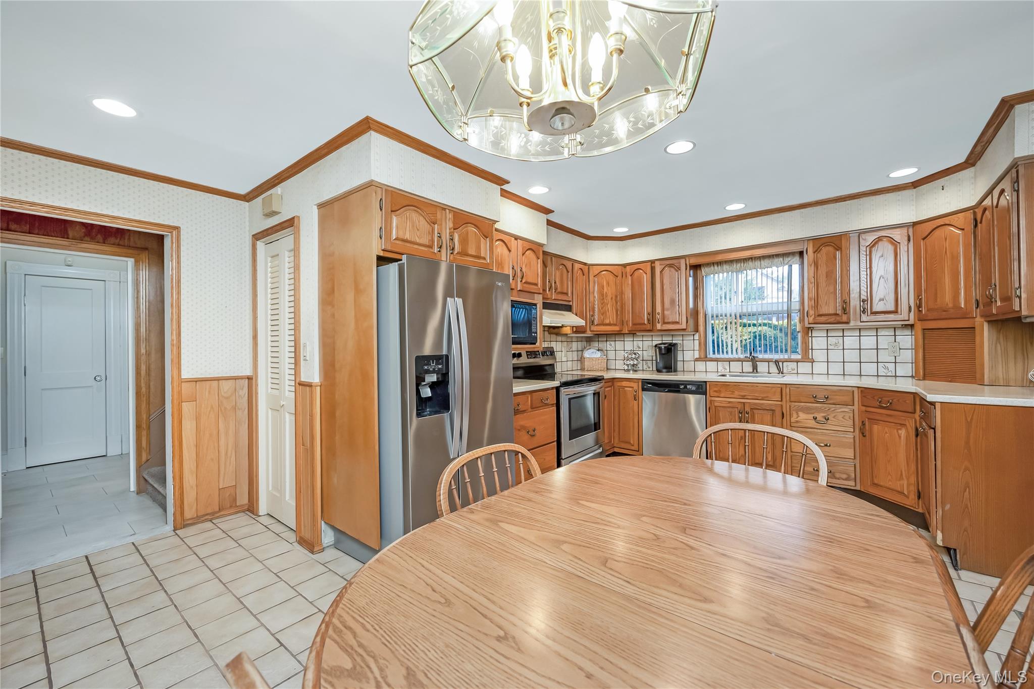 215 Conklin Street Farmingdale, NY 11735 - Photo 19 of 50 a kitchen with stainless steel appliances granite countertop a refrigerator a stove a sink dishwasher and a dining table with wooden floor