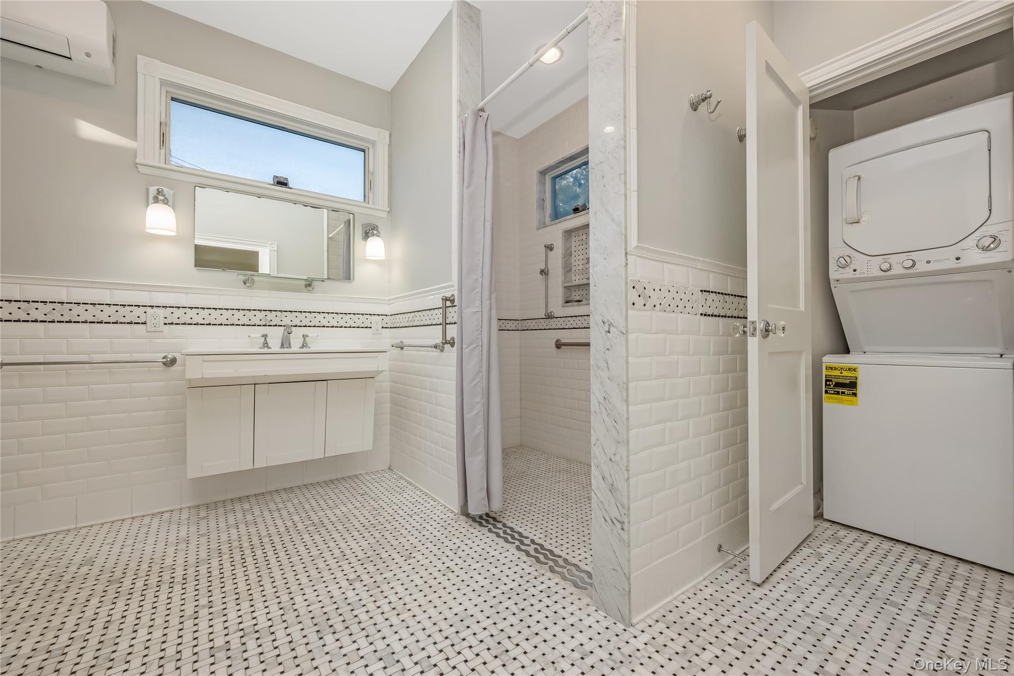 215 Conklin Street Farmingdale, NY 11735 - Photo 29 of 50 a bathroom with a sink a mirror and a shower