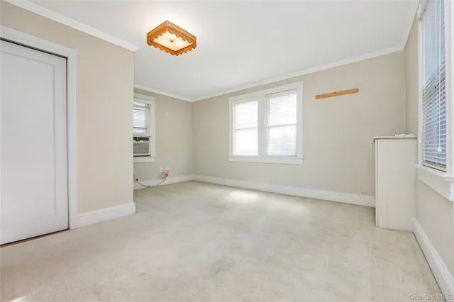 an empty room with windows and closet