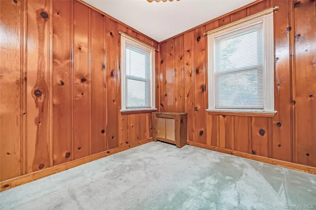 a room with a chair and a potted plant