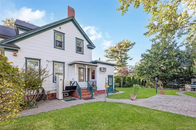 a view of a house with a backyard and a patio