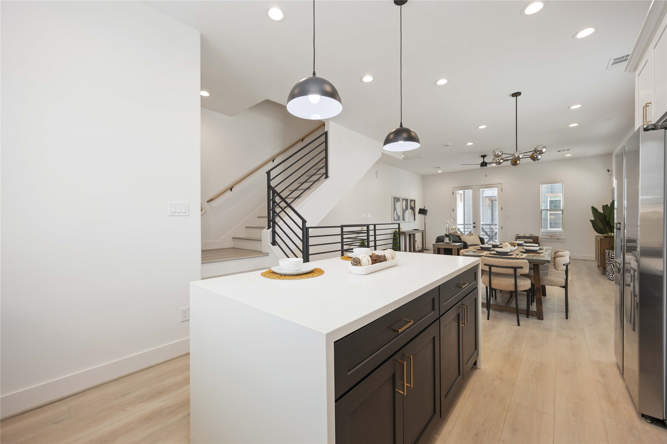 7805 Amelia Road, Unit B Houston, TX 77055 - Photo 15 of 34 a kitchen with a stove a kitchen island a dining table and chairs