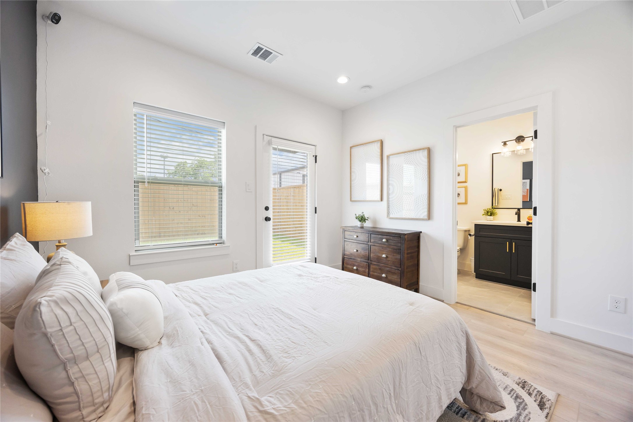 7805 Amelia Road, Unit B Houston, TX 77055 - Photo 18 of 34 a bedroom with a bed and a large mirror