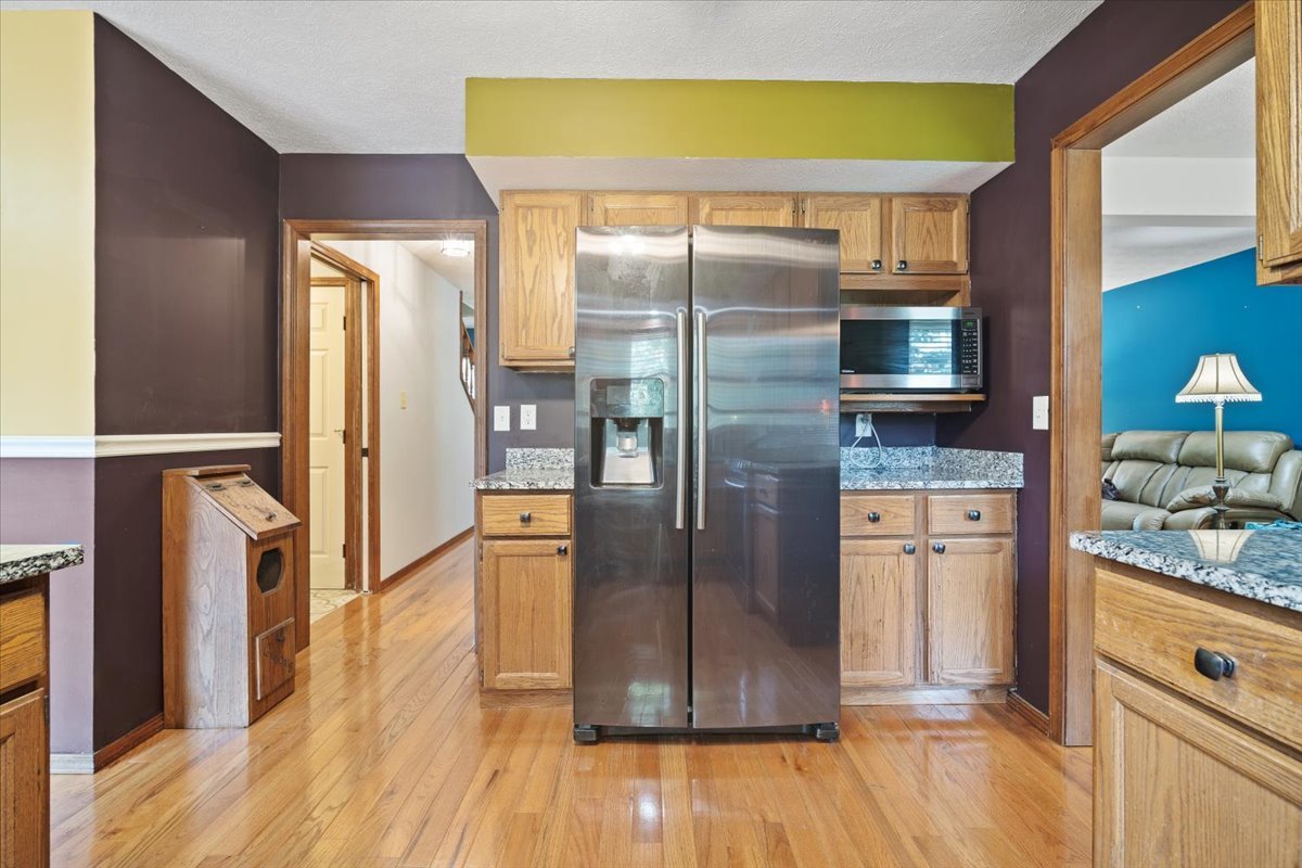 400 Park Pl Drive Normal, IL 61761 - Photo 11 of 33 a kitchen with granite countertop a refrigerator and wooden floor