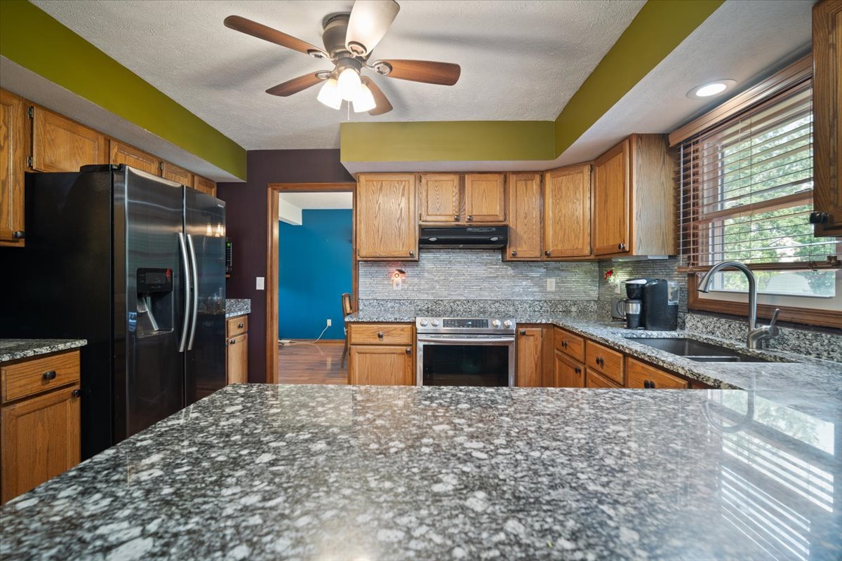 400 Park Pl Drive Normal, IL 61761 - Photo 12 of 33 a kitchen with stainless steel appliances granite countertop a sink stove and refrigerator