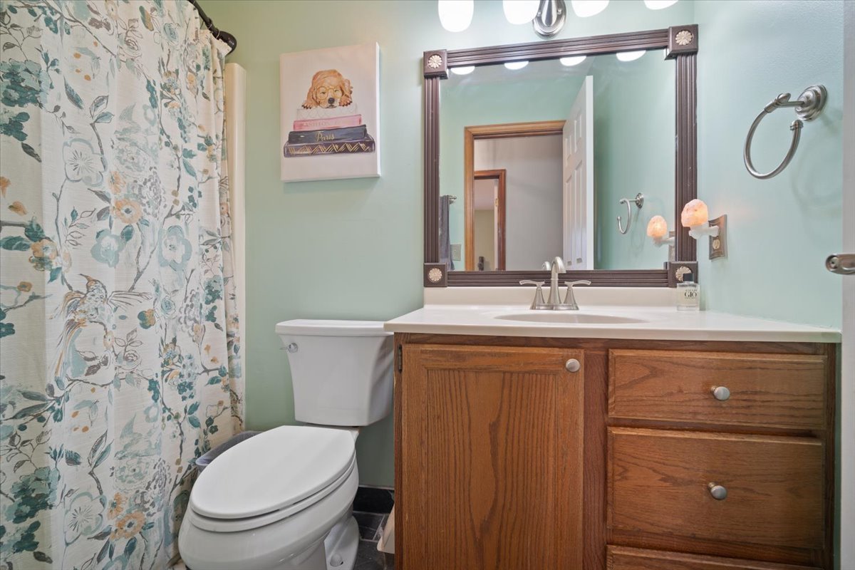 400 Park Pl Drive Normal, IL 61761 - Photo 19 of 33 a bathroom with a granite countertop toilet sink and mirror
