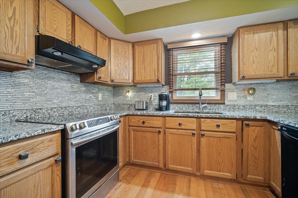 400 Park Pl Drive Normal, IL 61761 - Photo 9 of 33 a kitchen with granite countertop cabinets stainless steel appliances a sink and window