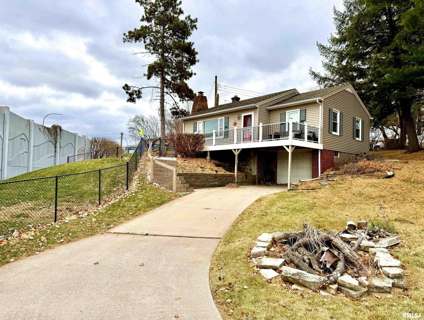 2003 19th Street Moline, IL 61265 - Photo 1 of 39 a front view of a house with a yard table and chairs
