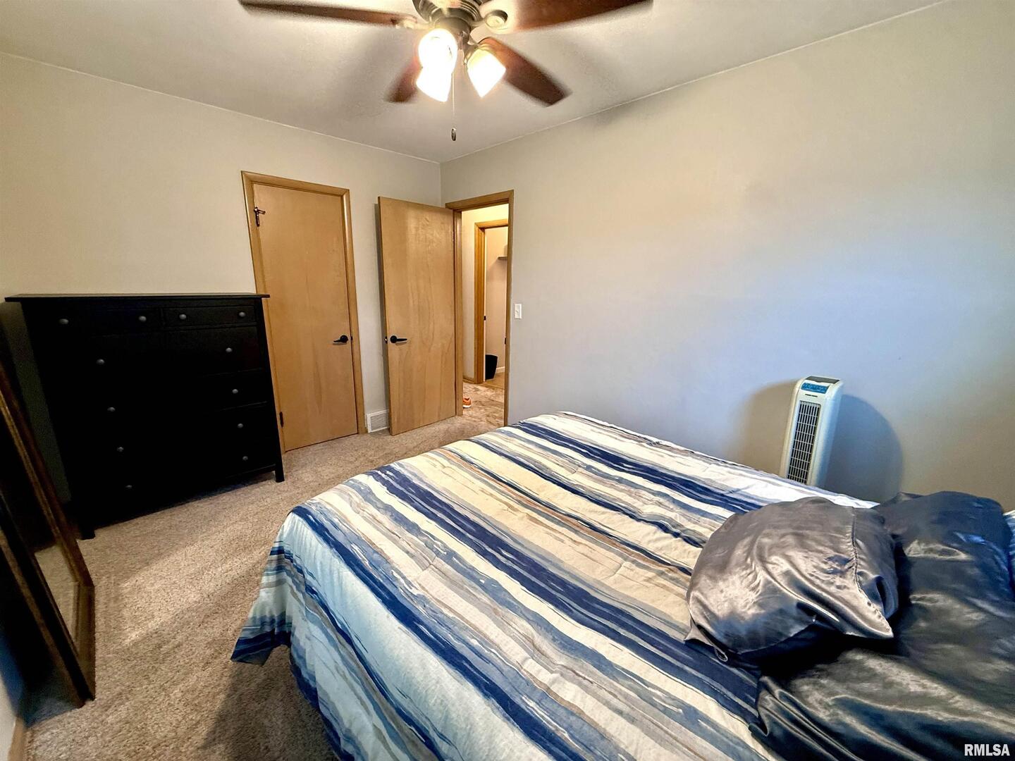 2003 19th Street Moline, IL 61265 - Photo 16 of 39 a bedroom with a bed and a chandelier