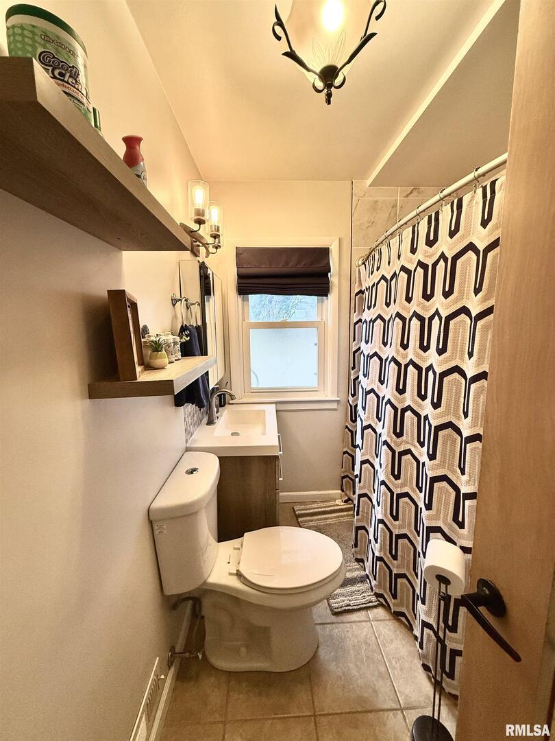 2003 19th Street Moline, IL 61265 - Photo 20 of 39 a bathroom with a toilet a sink and a shower