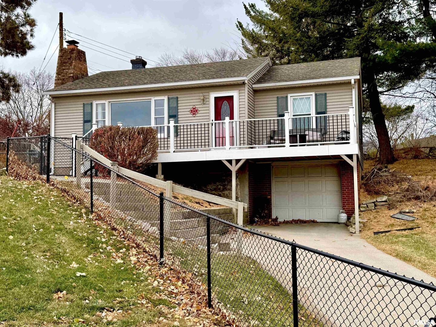 2003 19th Street Moline, IL 61265 - Photo 2 of 39 front view of house with large windows and a table