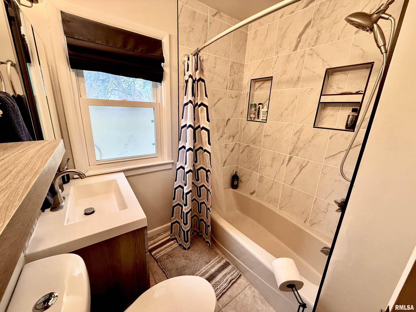 2003 19th Street Moline, IL 61265 - Photo 21 of 39 a bathroom with a sink toilet and shower