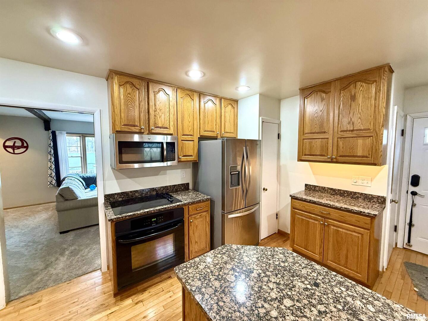 2003 19th Street Moline, IL 61265 - Photo 5 of 39 a kitchen with granite countertop a refrigerator stove and oven