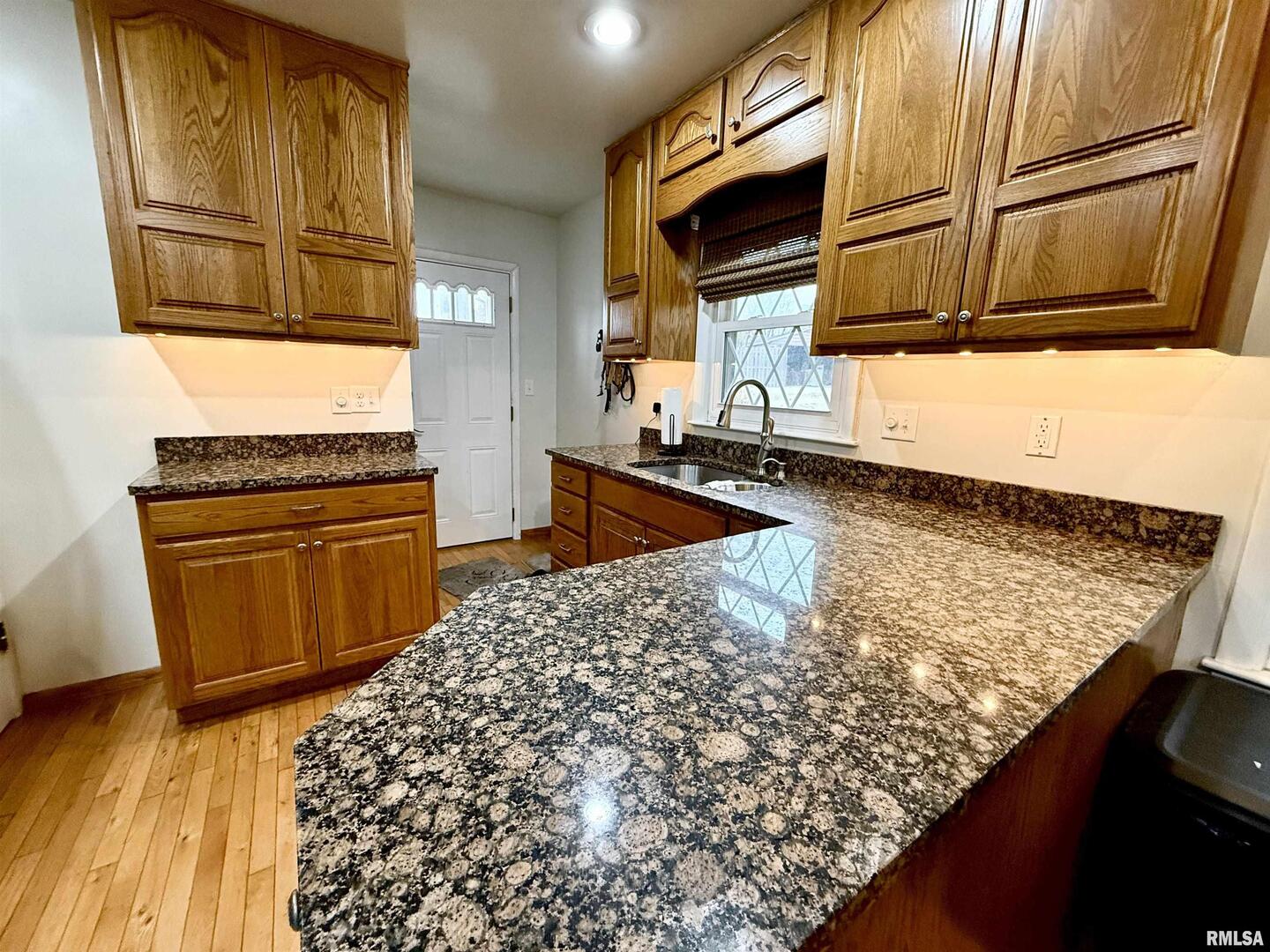 2003 19th Street Moline, IL 61265 - Photo 7 of 39 a kitchen with wooden cabinets and a stove top oven