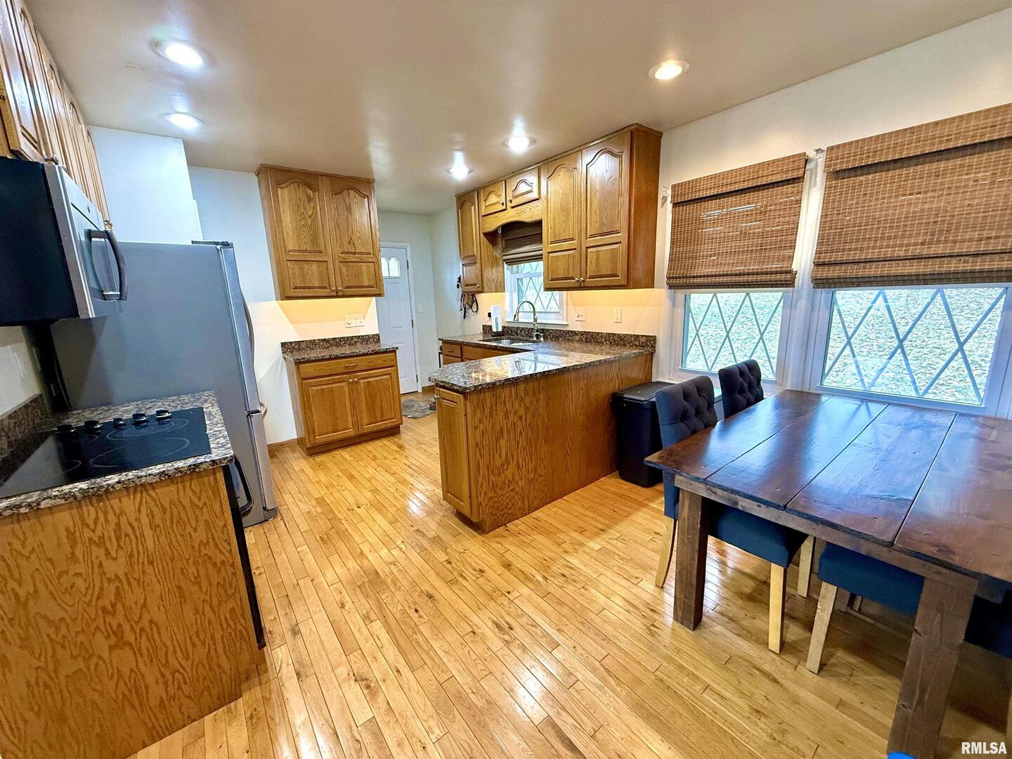 2003 19th Street Moline, IL 61265 - Photo 8 of 39 a kitchen with stainless steel appliances granite countertop a sink counter space and a window
