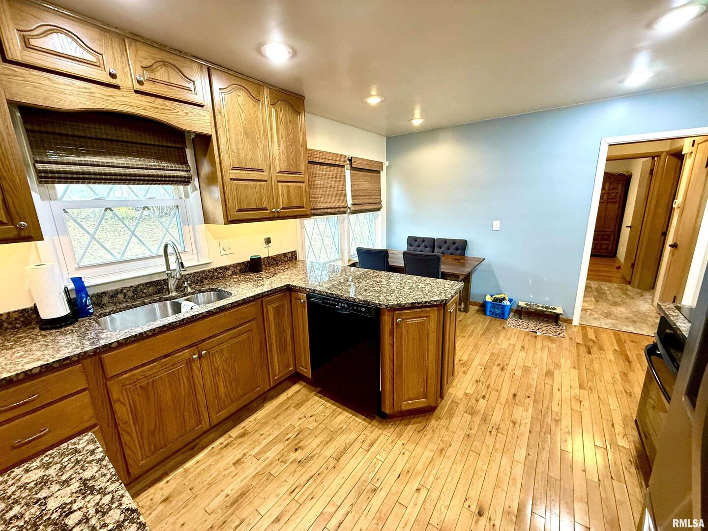 2003 19th Street Moline, IL 61265 - Photo 9 of 39 a kitchen with stainless steel appliances granite countertop a sink stove and wooden cabinets