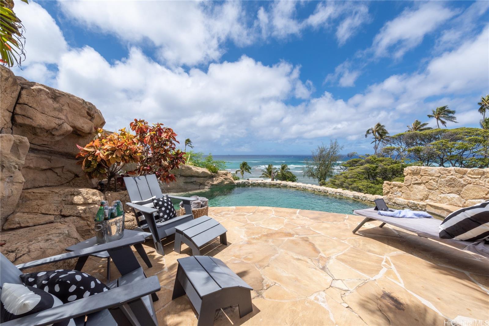 3220 Diamond Head Road, Unit 5 Honolulu, HI 96815 - Photo 1 of 1 Coral rock and a waterfall encircle this unique hillside pool that looks out over the surf and Leahi Park.