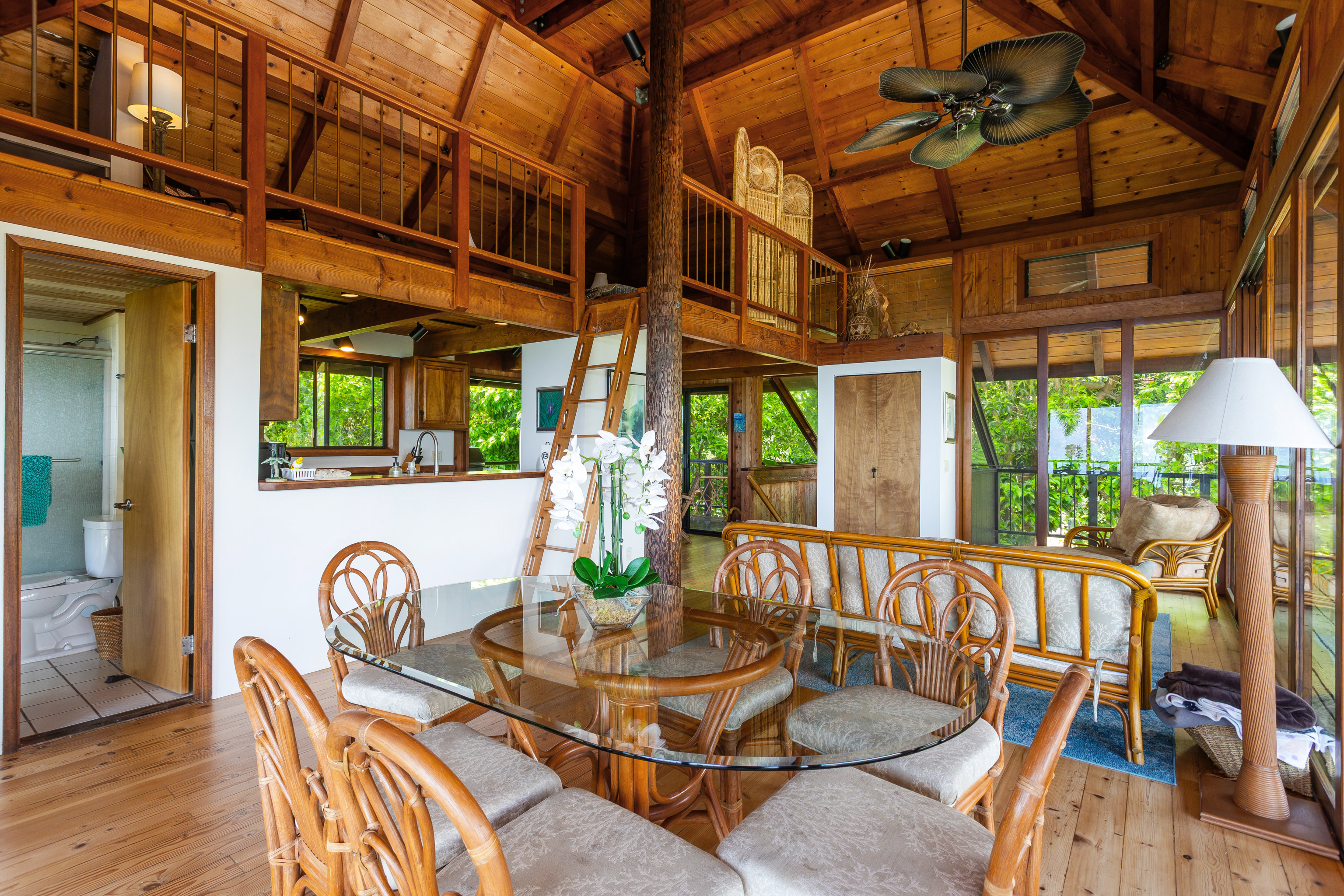 82-5971 Government Main Road Captain Cook, HI 96704 - Photo 5 of 30 a view of a patio with a table and chairs under an umbrella with wooden floor