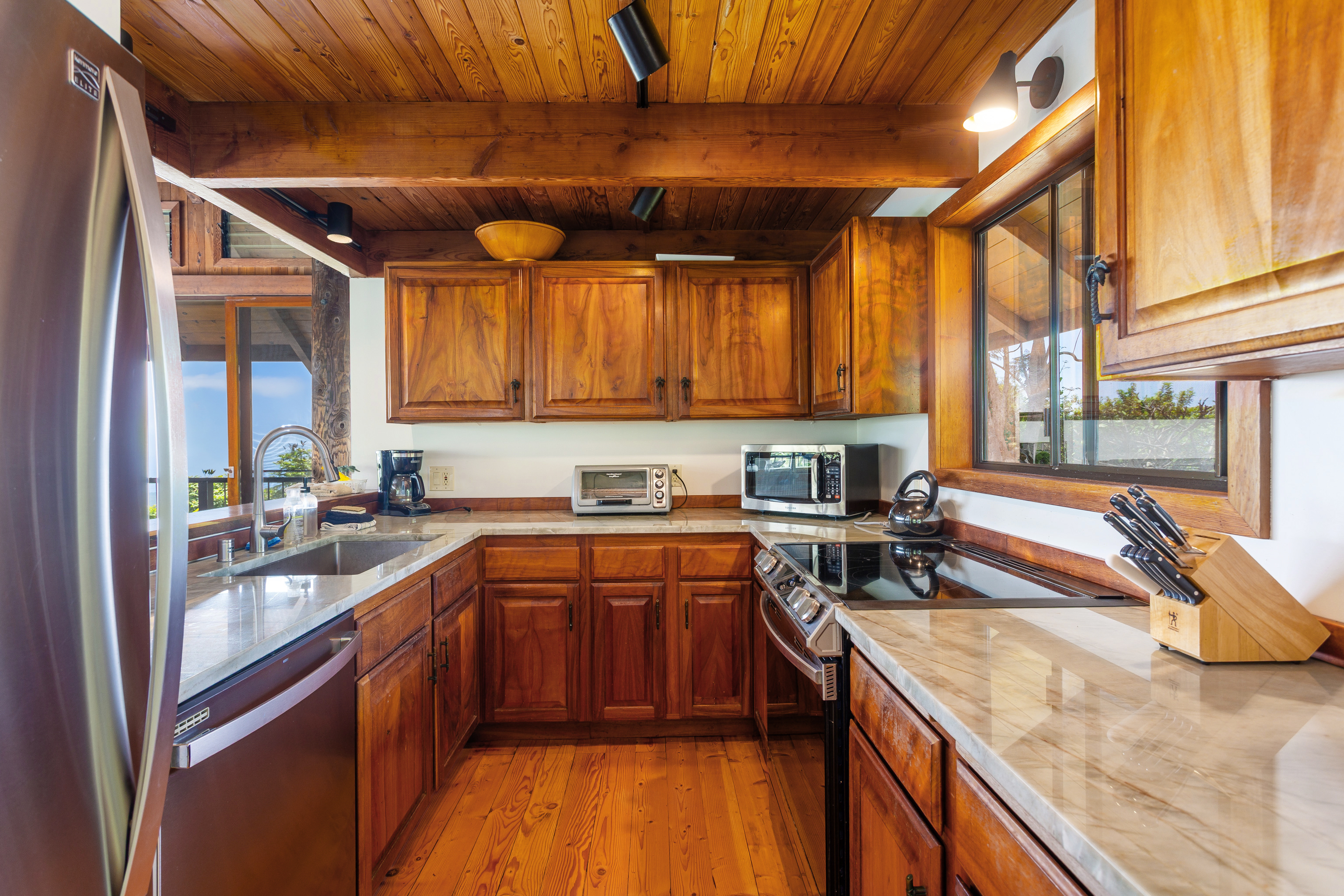 82-5971 Government Main Road Captain Cook, HI 96704 - Photo 8 of 30 a kitchen with stainless steel appliances granite countertop sink stove and cabinets