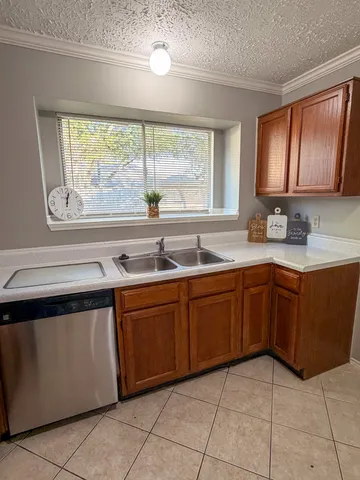 a kitchen with a sink a stove cabinets and outdoor space