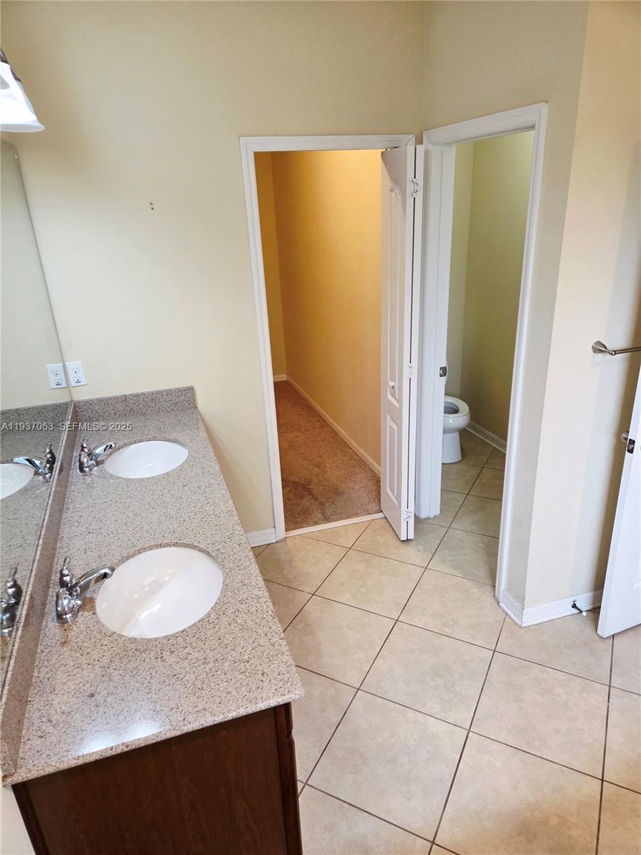 9181 Shepton Street, Unit 9181 Orlando, FL 32825 - Photo 18 of 41 a bathroom with a sink and a mirror