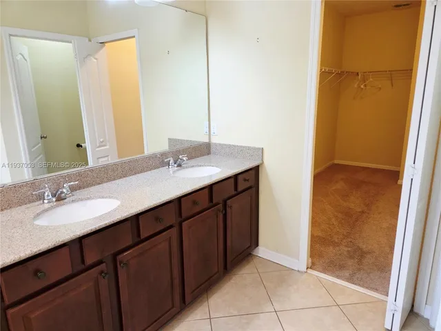 a white toilet sitting next to a white wall