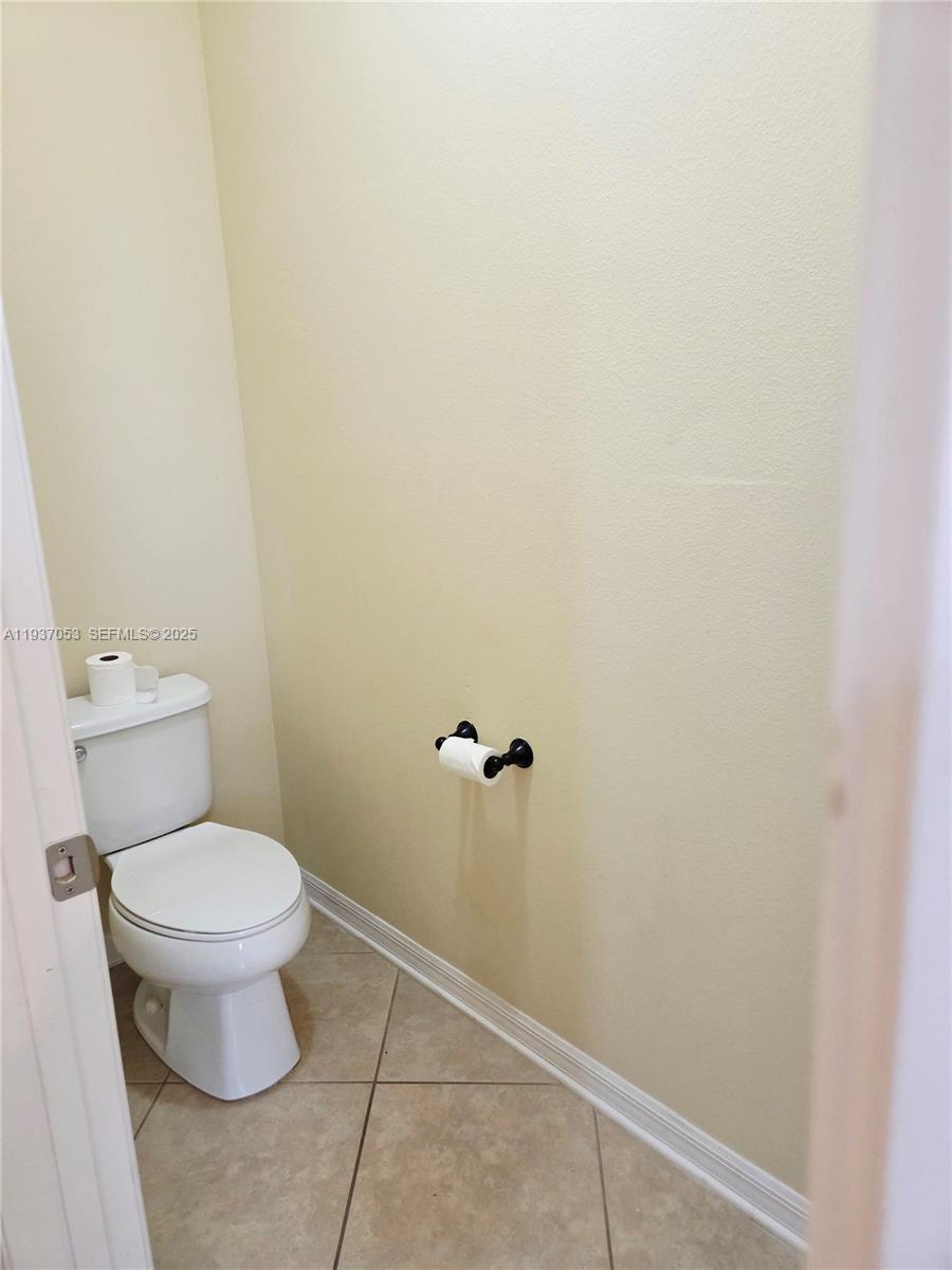 9181 Shepton Street, Unit 9181 Orlando, FL 32825 - Photo 20 of 41 a white toilet sitting next to a white wall