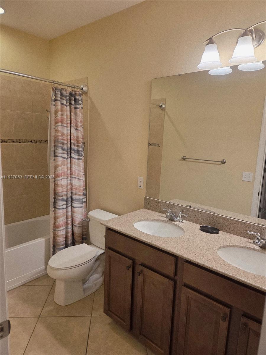 9181 Shepton Street, Unit 9181 Orlando, FL 32825 - Photo 26 of 41 a bathroom with a sink a toilet and shower
