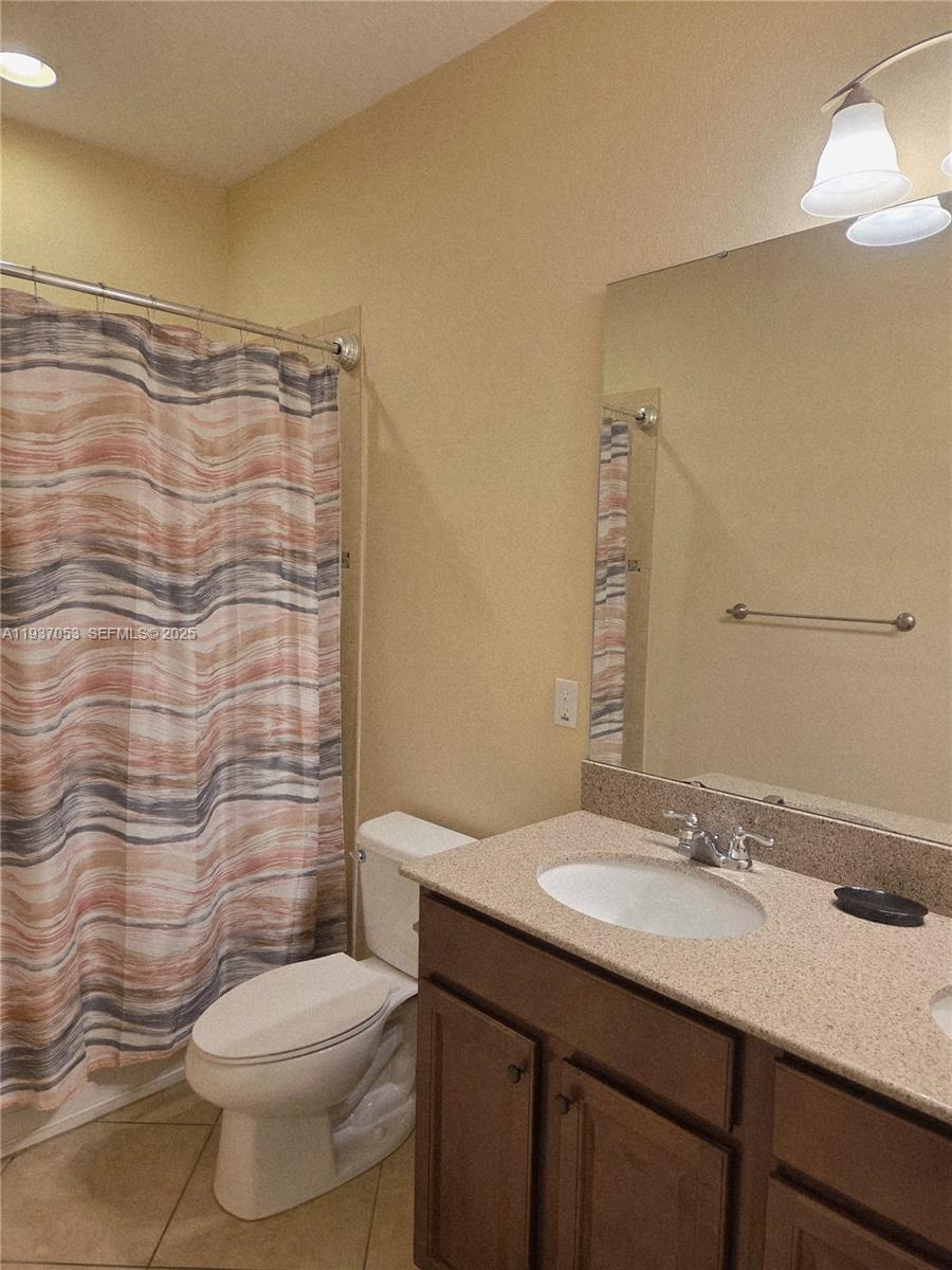 9181 Shepton Street, Unit 9181 Orlando, FL 32825 - Photo 27 of 41 a bathroom with a granite countertop sink toilet and shower