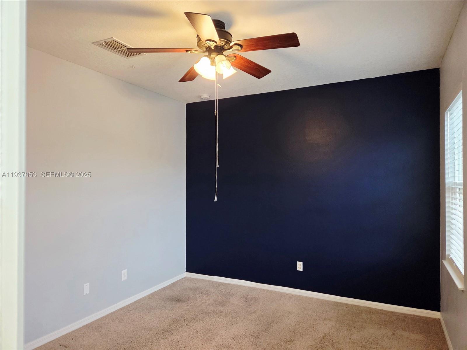 9181 Shepton Street, Unit 9181 Orlando, FL 32825 - Photo 38 of 41 an empty room with a ceiling fan and a fan