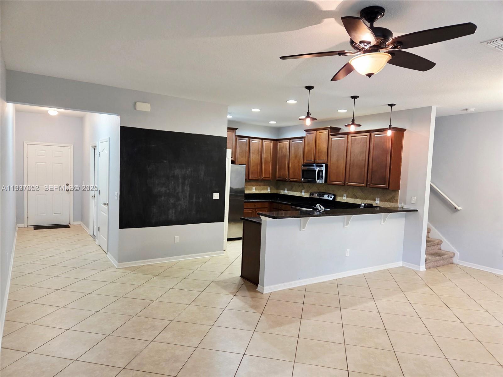 9181 Shepton Street, Unit 9181 Orlando, FL 32825 - Photo 5 of 41 a view of kitchen with refrigerator and microwave