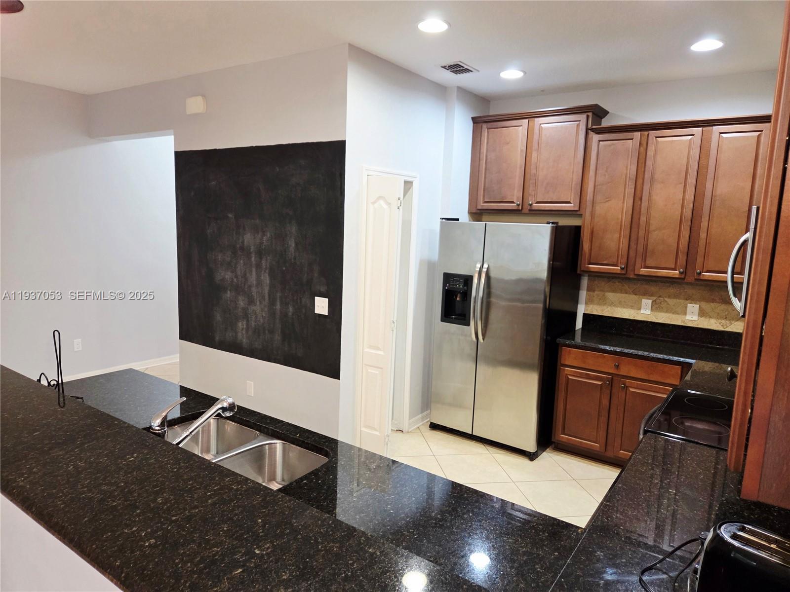 9181 Shepton Street, Unit 9181 Orlando, FL 32825 - Photo 8 of 41 a kitchen with stainless steel appliances granite countertop a refrigerator and a stove