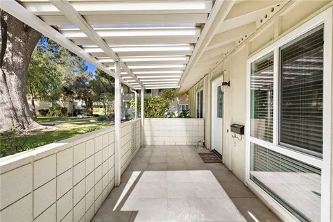 a view of a porch with wooden floor and stairs