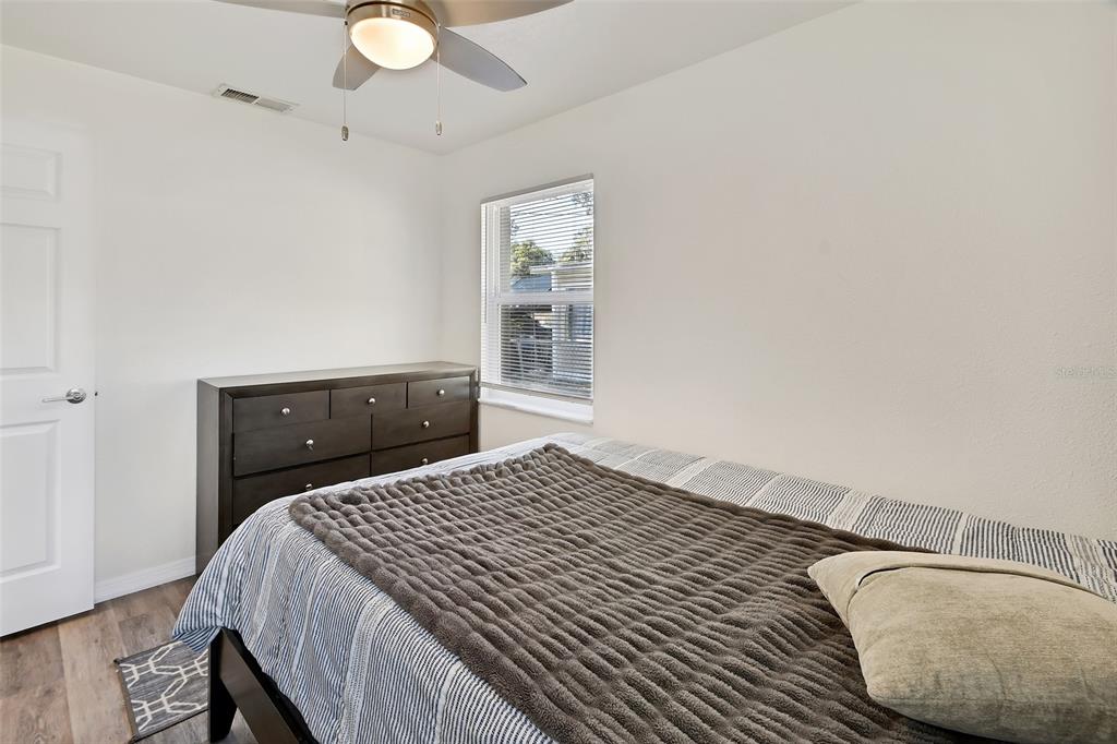 1015 East Howry Avenue Deland, FL 32724 - Photo 14 of 26 a bedroom with a bed and a window