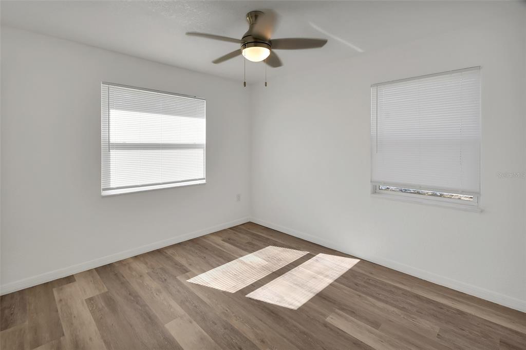 1015 East Howry Avenue Deland, FL 32724 - Photo 16 of 26 a view of empty room with wooden floor and fan