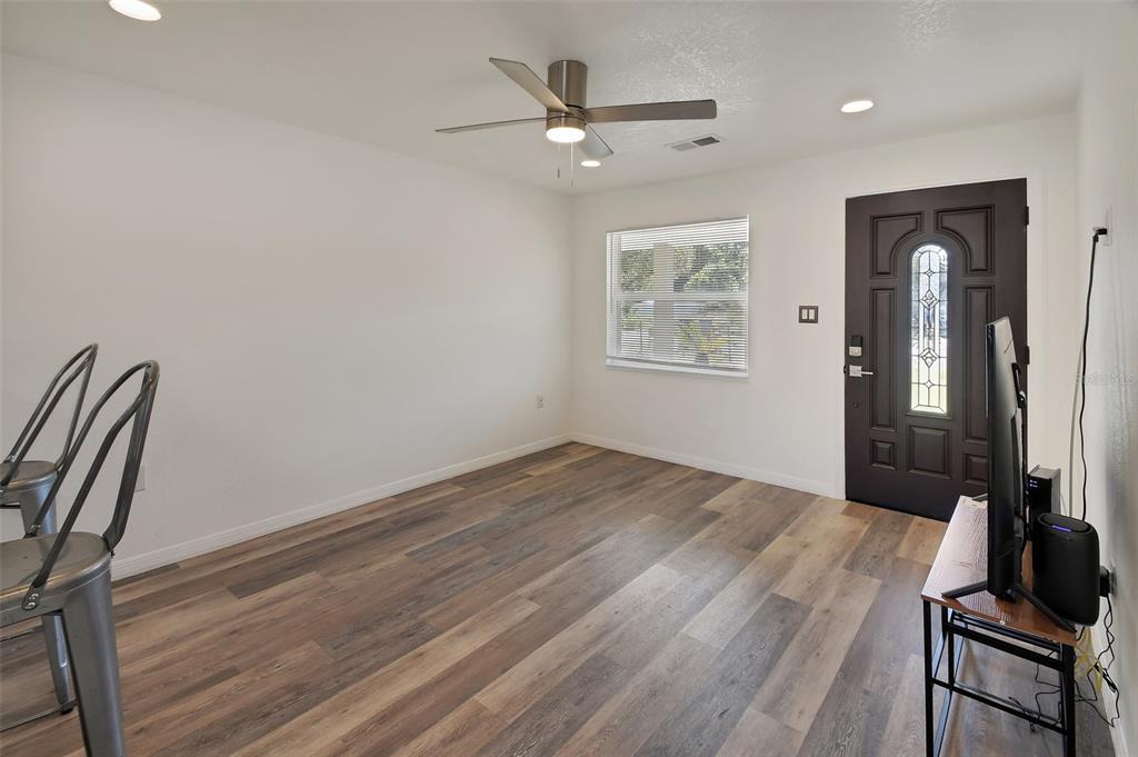 1015 East Howry Avenue Deland, FL 32724 - Photo 4 of 26 wooden floor in an empty room with a window