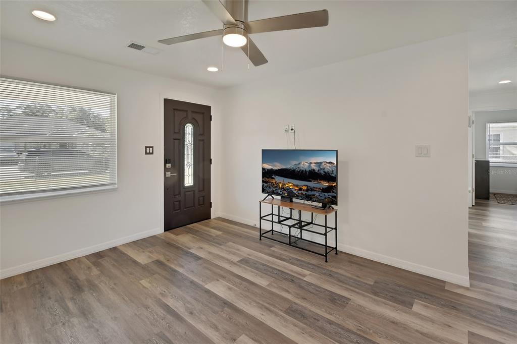 1015 East Howry Avenue Deland, FL 32724 - Photo 5 of 26 wooden floor in an empty room with a window