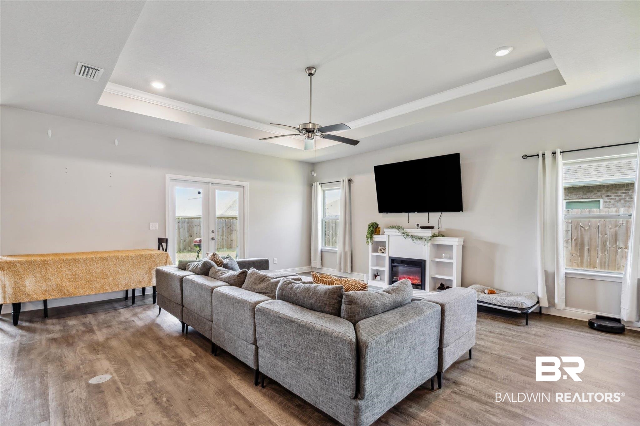 10501 Loamy Avenue Mobile, AL 36695 - Photo 6 of 30 Living room with french doors, ceiling fan, hardwood / wood-style floors, and a tray ceiling